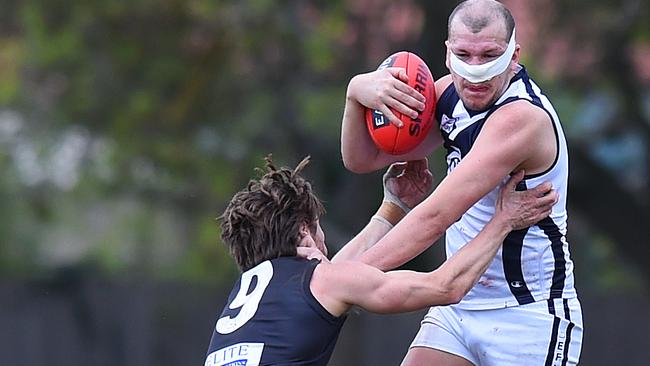 Lauchlan Craig gives East Burwood’s Jason Kennedy the ‘don’t argue’. Picture: Josie Hayden