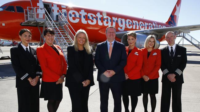 BRISBANE, AUSTRALIA - NewsWire Photos JUNE 19, 2023: Jetstar Group CEO Stephanie Tully and Brisbane Airport CEO Gert-Jan de Graaff, centre, pose with airline staff during an announcement at Brisbane Airport. The low-cost carrier will reveal more great low fares, new long-haul routes and extra frequency to popular international destinations. Picture: NCA NewsWire/Tertius Pickard