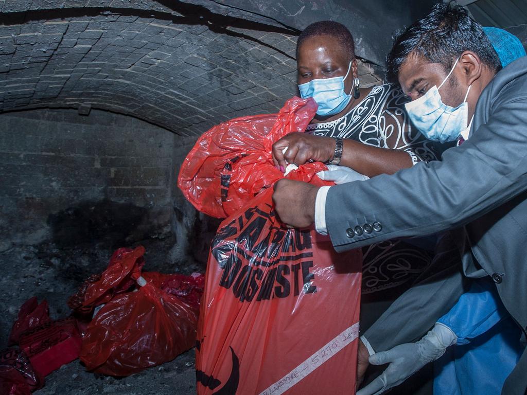 Kandodo C) puts packs of expired COVID-19 Astra Zeneca in a pharmaceutical incinerator to destroy them at Kamuzu Central Hospital in Lilongwe. Picture: Amos Gumulira