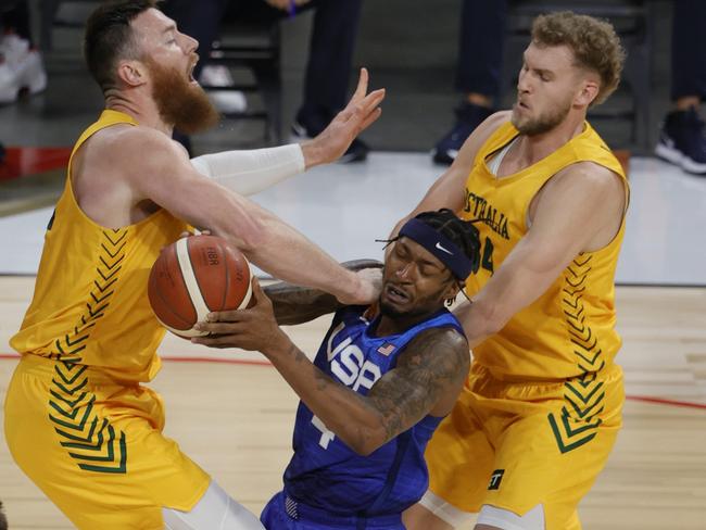 LAS VEGAS, NEVADA - JULY 12: Bradley Beal #4 of the United States drives into Aron Baynes #12 of the Australia Boomers as Jock Landale #34 of the Boomers defends during an exhibition game at Michelob Ultra Arena ahead of the Tokyo Olympic Games on July 12, 2021 in Las Vegas, Nevada.   Ethan Miller/Getty Images/AFP == FOR NEWSPAPERS, INTERNET, TELCOS & TELEVISION USE ONLY ==