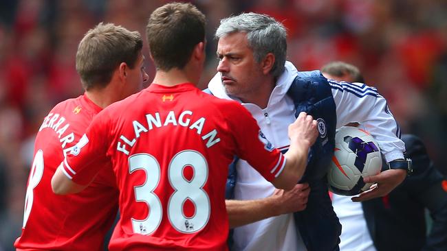 LIVERPOOL, ENGLAND - APRIL 27: (EDITORS NOTE: Retransmission of image 487057275 with alternate crop.) Steven Gerrard and Jon Flanagan of Liverpool have words with Jose Mourinho manager of Chelsea as he holds onto the ball during the Barclays Premier League match between Liverpool and Chelsea at Anfield on April 27, 2014 in Liverpool, England. (Photo by Clive Brunskill/Getty Images)