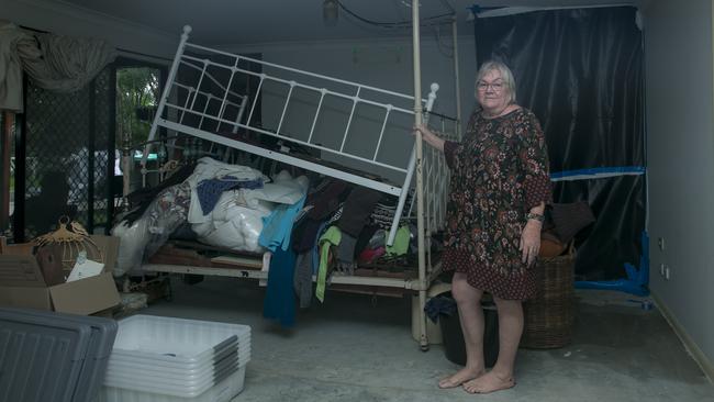 Donna Bressow in the lower part of the Helensvale home which she shares with her mother Eleanor, which remains unusable 12 months on from the Christmas night storm. Picture: Glenn Campbell