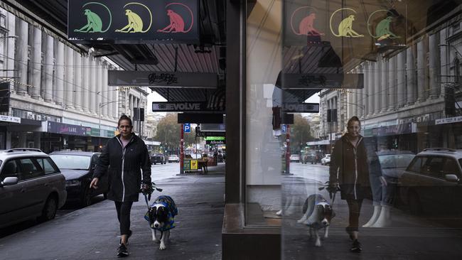 A woman walks past Three Monkeys bar in Prahran, Melbourne, on Thursday. the bar is on the list of exposure sites. Picture: Getty Images
