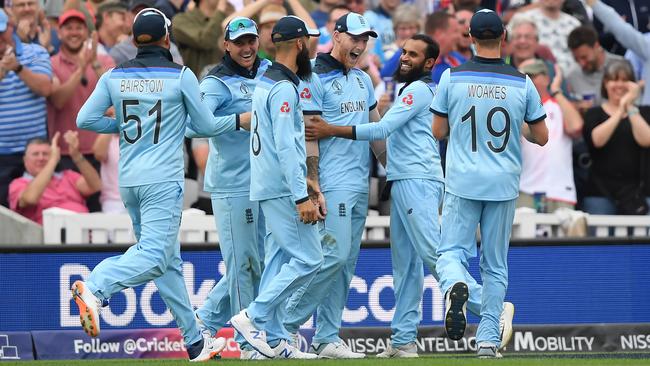 Ben Stokes is mobbed by England team-mates after taking the catch of Andile Phehlukwayo