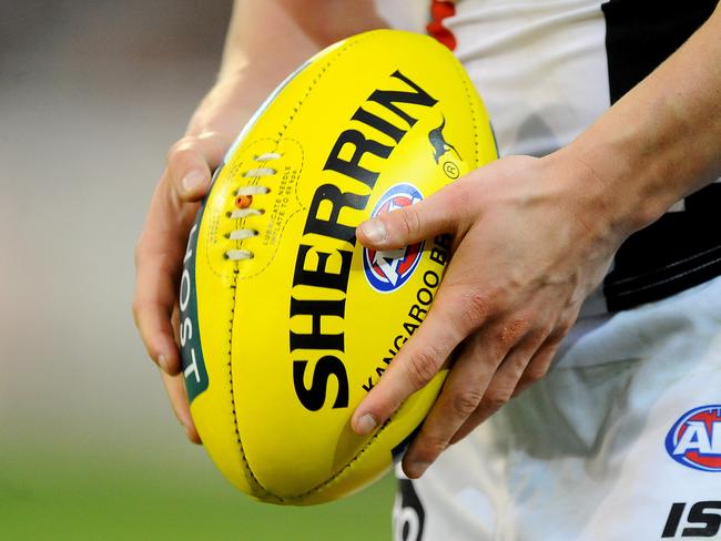 Generic photo of a player holding a ball, during the Round 22 AFL match between the Richmond Tigers and St Kilda Saints at the MCG in Melbourne, Sunday, 24 Aug. 2014. (AAP Image/Joe Castro) NO ARCHIVING, EDITORIAL USE ONLY