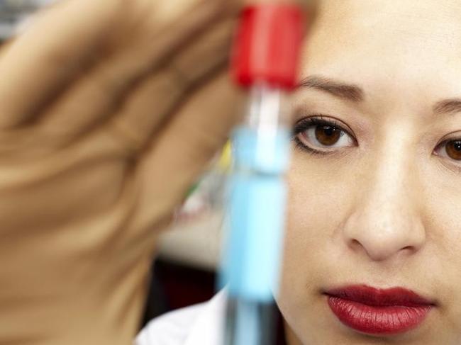 Lab technician with a vial