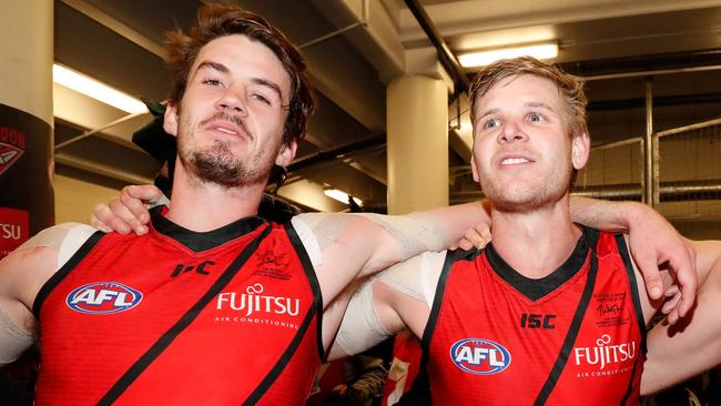 Michael Hartley (left) and Michael Hurley of the Bombers sing the team song after the win over St Kilda. (Photo by Adam Trafford/AFL Media/Getty Images)