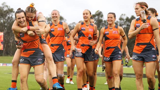 GWS players enjoy their first win of the season.