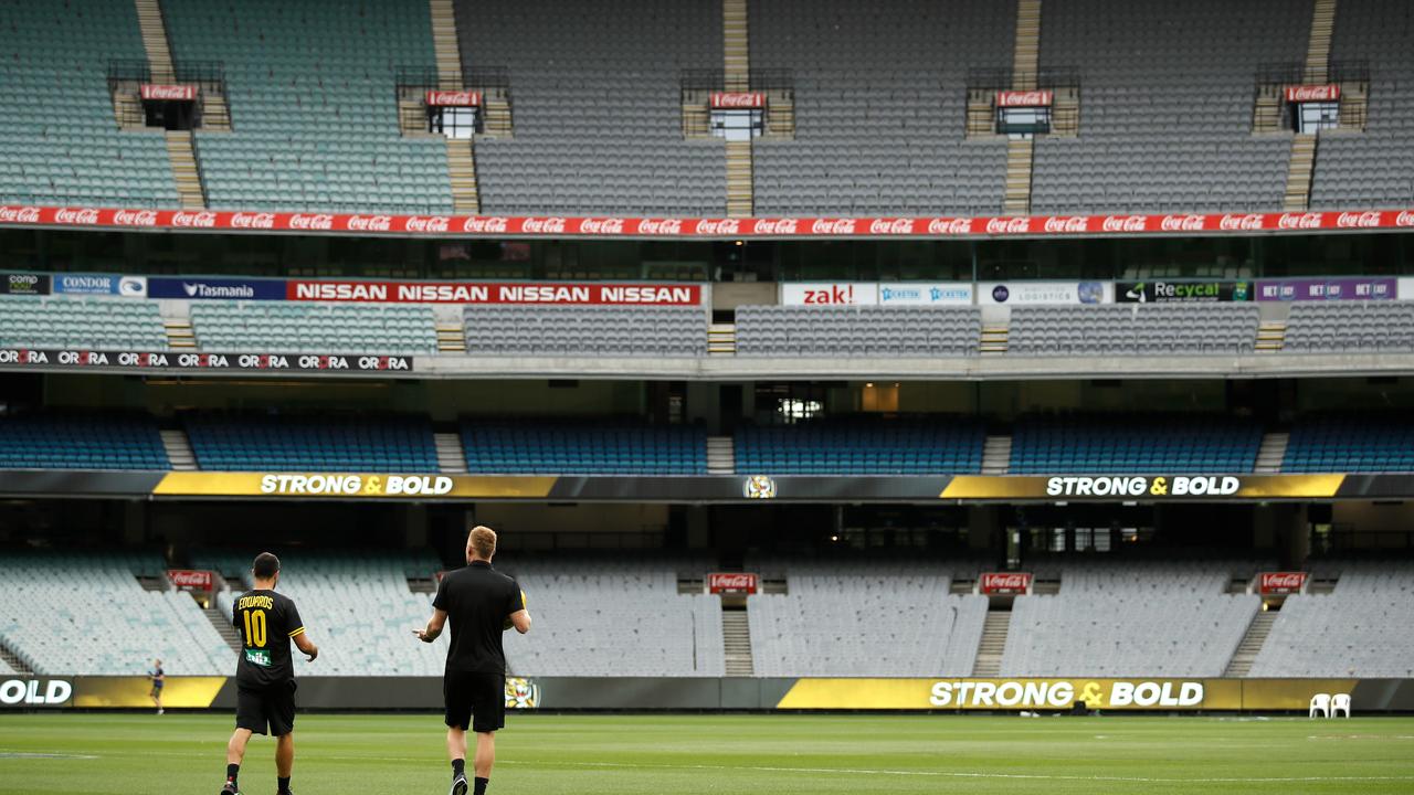 Shane Edwards and Nick Vlastuin of the Tigers are seen walking on to the ground before the 2020 AFL Round 1 match. Picture: Getty Images