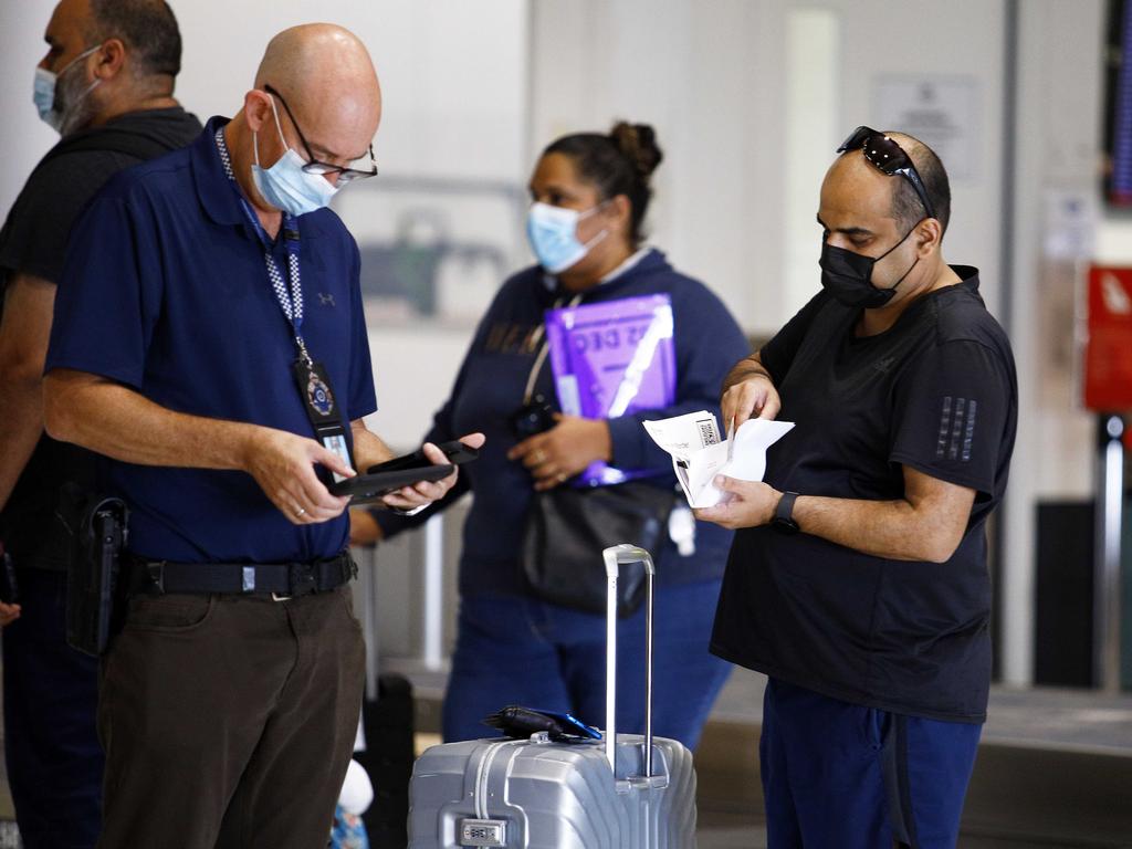 Passengers arriving from Sydney into Brisbane airport being processed by border police last week. Picture: NCA NewsWire/Tertius Pickard