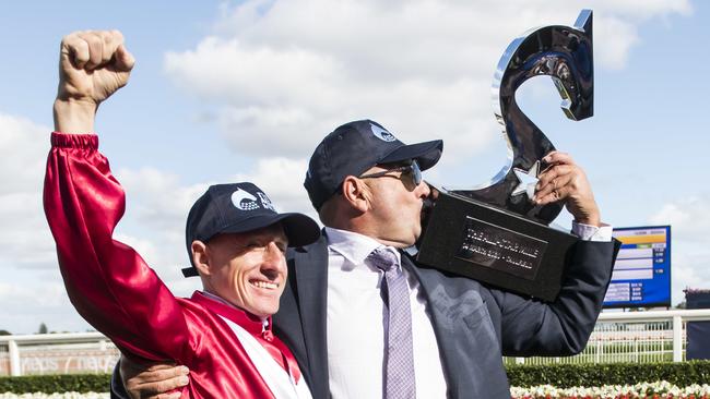 Jockey William Pike and trainer Grant Williams show off the spoils of victory in the All-Star Mile. Picture: AAP