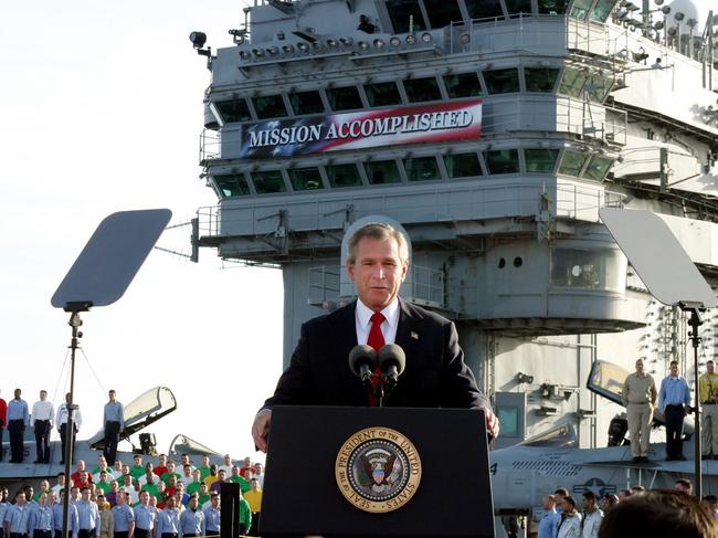 Banner moment: George W. Bush, aboard the aircraft carrier USS Abraham Lincoln in 2003, declares the end of major combat in Iraq. Picture: AP