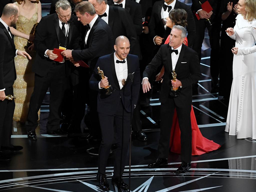 ‘La La Land’ producer Fred Berger speaks at the microphone with producer Marc Platt as production staff consult behind them regarding a presentation error of the “Best Picture” award (later awarded to ‘Moonlight’) onstage during the 89th Annual Academy Awards. Picture: Getty