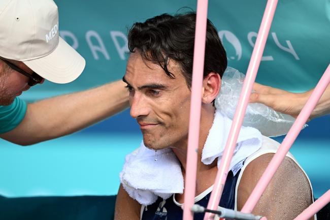 France's Youssef Krou cools off in the beach volleyball