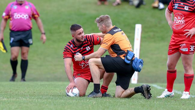 Riley Baharov receiving treatment after a head-knock. Picture: DC Sports Photography