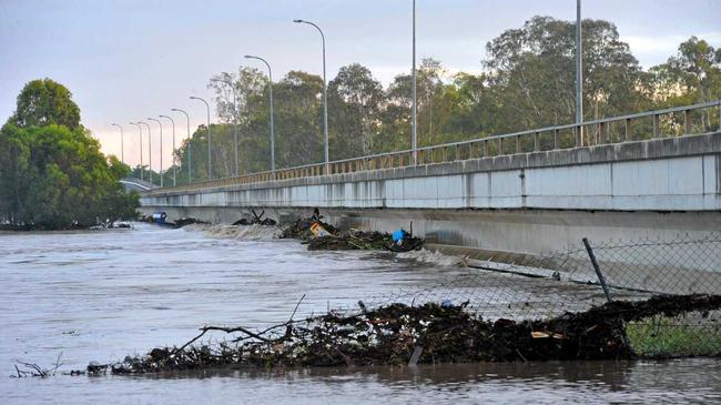 FLOODWATERS RECEDE: Debris clings to the underside of Tallon Bridge and after days of severe flooding the record floodwaters in Bundaberg finally recede. Photo: Max Fleet / NewsMail. Picture: Max Fleet BUN300113TAL1