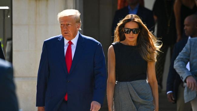 Former US President Donald Trump and his wife, Melania Trump, leave a polling station after voting in the US midterm elections in Palm Beach, Florida, on November 8, 2022. (Photo by Eva Marie UZCATEGUI / AFP)