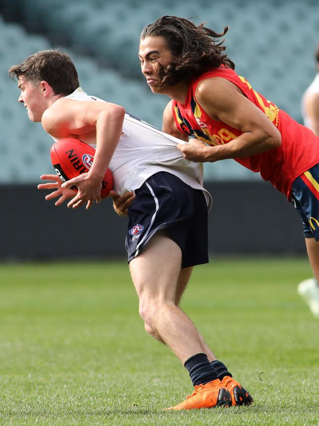 Kai Pudney makes a tackle against Vic Country at Adelaide Oval during the NAB AFL U18 Championships. Picture: AAP Image/Russell Millard