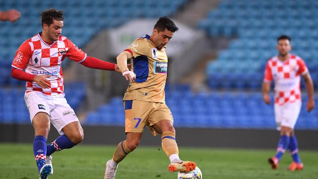 Roman Hofmann of the Knights (left) competes with Dimitri Petratos.