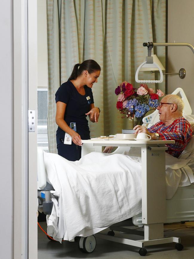 St Vincent's Private Hospital nurse Courtney Bell chats with patient Leo Schofield.