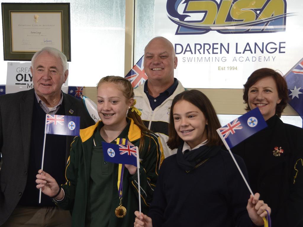 Toowoomba Regional Council Mayor Paul Antonio, former Olympian Darren Lange and Toowoomba and Surat Basin Enterprise CEO Ali Davenport with swimmers Bronte Wade, 12, and Emmi Lange, 13, celebrating the announcement of Brisbane as the host city for the 2032 Olympic Games.