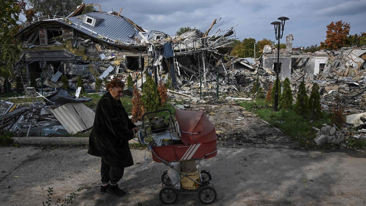 A resident walks past a destroyed building in Mykolaivka, eastern Ukraine. Picture: Juan Barreto/AFP