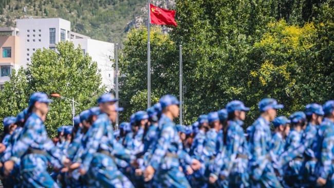 Minister for Defence Peter Dutton says a war with China “is a question for the Chinese”. Freshmen attend a military training at Shandong University of Arts on September 9 in Jinan. Picture: Getty Images