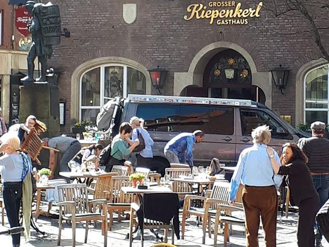 The scene outside the restaurant in Muenster, Germany, after a driver ploughed into groups of people sitting at tables outside.