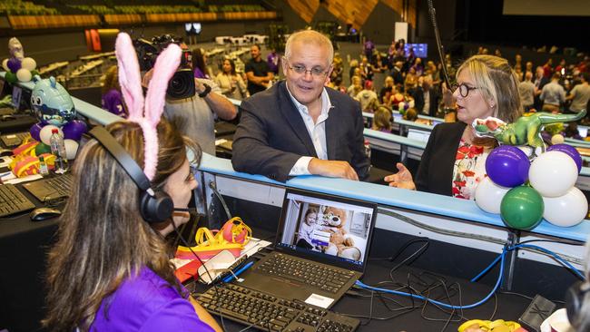 Prime Minister Scott Morrison with HWT chairman Penny Fowler talking to volunteers in the telephone room during the 2022 Good Friday Appeal. Picture: Aaron Francis / Herald Sun