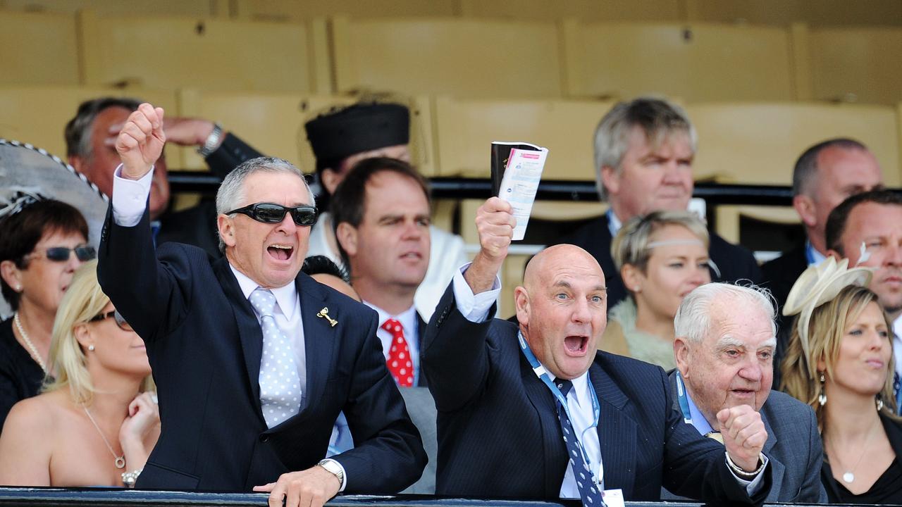 Flemington. Trainer Alan Scorse, LEFT, from Broadmeadow in NSW boots home their horse , Who's Ready, in Race 3 with the part owners