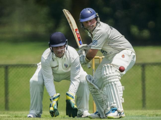 Red Hill captain Simon Dart keeps his eye on the ball in front of Long Island keeper Aiden McKenna on Saturday. Picture: Valeriu Campan