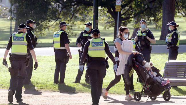 Police were accused of being draconian and heavy handed int he enforcement of lockdowns in Victoria, pictured here mass-patrolling a park.