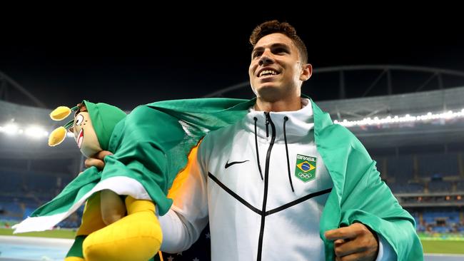 Thiago Braz da Silva of Brazil does a lap of honour with his national flag after winning the pole vault title.