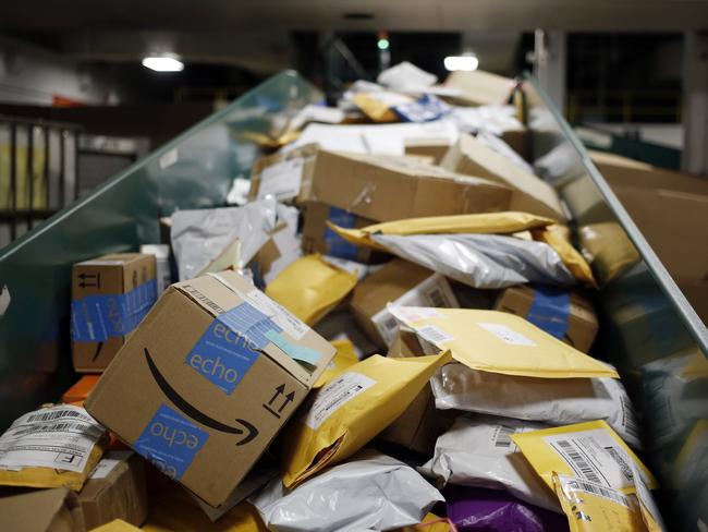 Amazon.com Inc. packages are seen on a conveyor belt with other small parcels at the United States Postal Service (USPS) sorting centre. Picture: Bloomberg