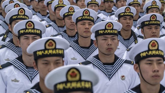 QINGDAO, CHINA - APRIL 21: Chinese sailors sit together  after performing signals with flags at a demonstration during a media tour of an open house at the PLA Navys Submarine Academy as part of events marking the 75th Anniversary of the founding of the countrys navy on April 21, 2024 in Qingdao, China. China is hosting the Western Pacific Naval Symposium this week. (Photo by Kevin Frayer/Getty Images)