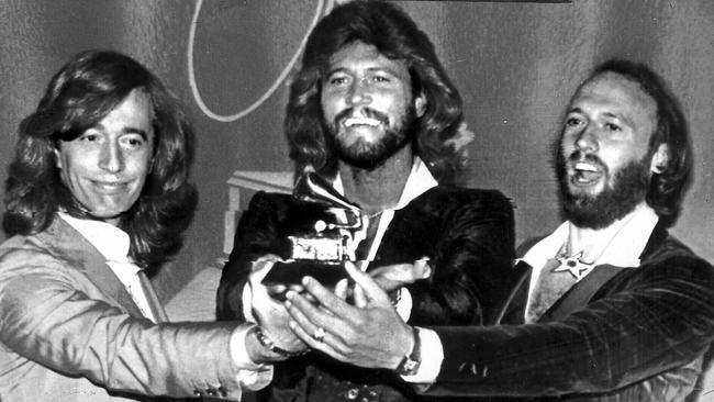 The Bee Gees win a Grammy for album of year for Saturday Night Fever. Members (L-R) Robin, Barry and Maurice Gibb in 1979.