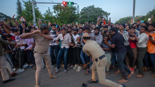 Police officers try to control fans of the Royal Challengers Bengaluru (RCB). (Photo by Abhishek Chinnappa/Getty Images)