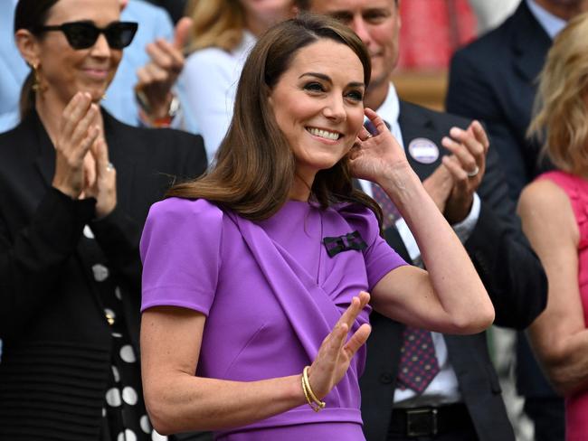 TOPSHOT - Britain's Catherine, Princess of Wales (C) waves as she arrives in the Royal Box on Centre Court to attend the men's singles final tennis match on the fourteenth day of the 2024 Wimbledon Championships at The All England Lawn Tennis and Croquet Club in Wimbledon, southwest London, on July 14, 2024. (Photo by ANDREJ ISAKOVIC / AFP) / RESTRICTED TO EDITORIAL USE