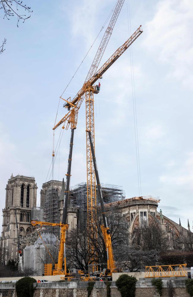 Cranes outside the Notre-Dame Cathedral in Paris, which was partially destroyed when fire broke out beneath the roof on April 15, 2019. Picture: AFP