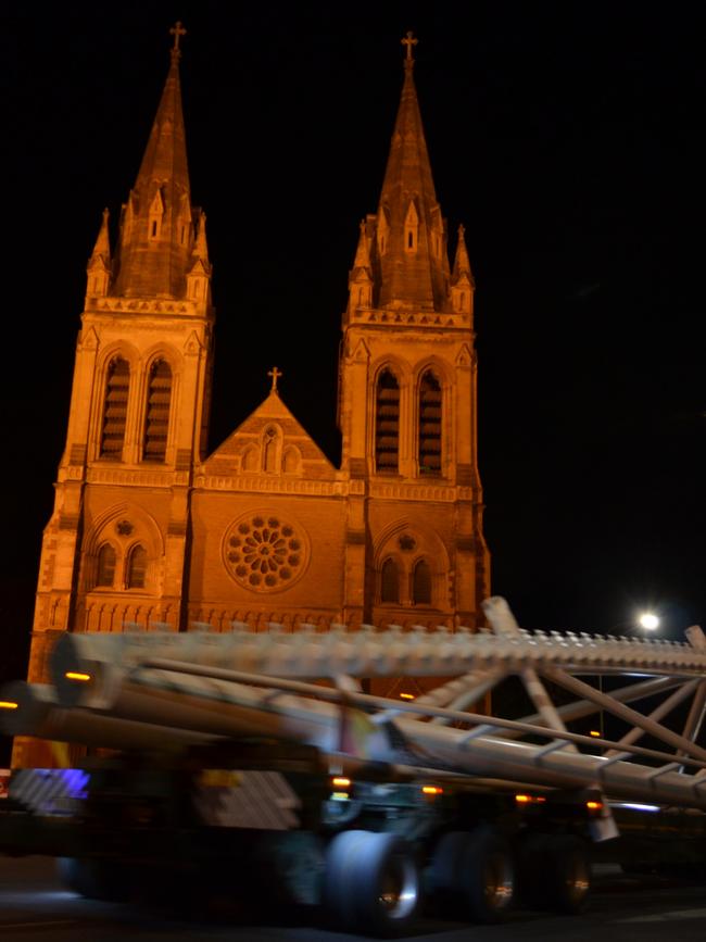 A 50 tonne canoe truss destined for Memorial Drive passes St Peter’s cathedral in the early hours of last Sunday morning. Pic supplied.