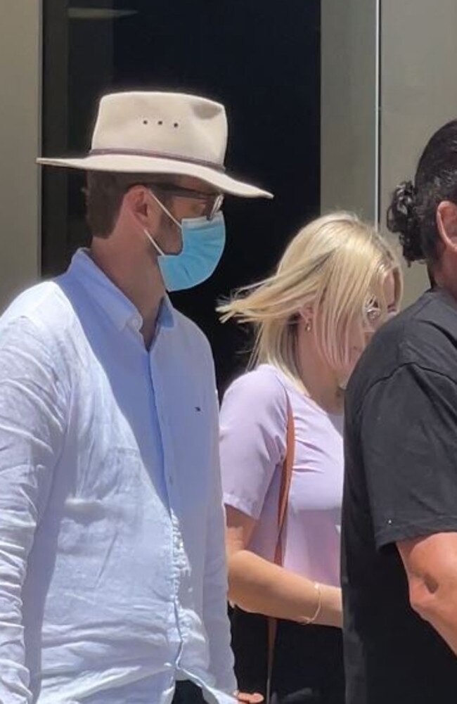 Jonathon Andrew Cooke, wearing a hat and mask, leaves Southport District Court.