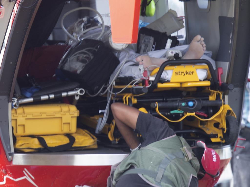 A victim of the White Island eruption is loaded into a rescue chopper at Whakatane Airport today. Picture: New Zealand Herald photograph by Alan Gibson/NZ Herald