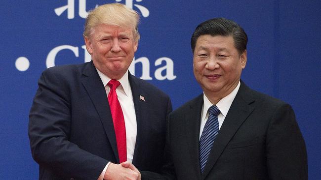 Donald Trump (L) and China’s President Xi Jinping shaking hands during a business leaders event at the Great Hall of the People in Beijing.