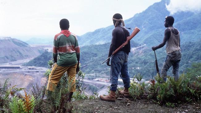 Bougainville Revolutionary Army guerillas stand guard above the Panguna mine in 1996.