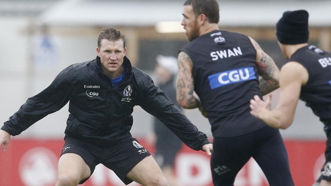 Collingwood training at Olympic Park. Coach Nathan Buckley plays the role of defender during a drill . Pic: Michael Klein