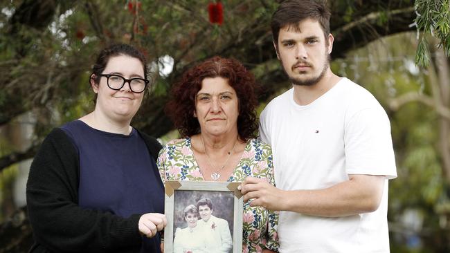 From right, Riley, Anita and Jessica Warburton with a picture of Michael and Anita. Picture: Josh Woning