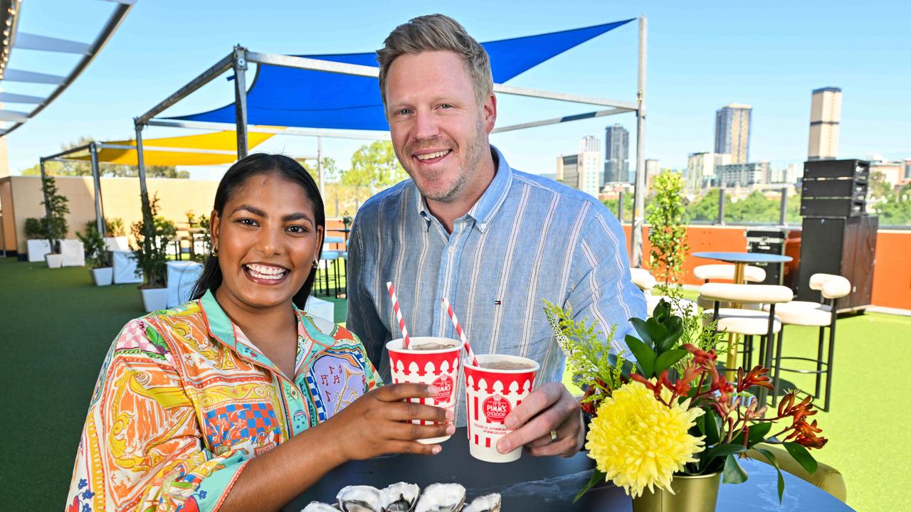 SACA members John Hinge and Hannah Douglas-Hill enjoy Pimms and oysters in the new Village Green-style members area on level 5 of the Riverbank Stand. Picture: Brenton Edwards