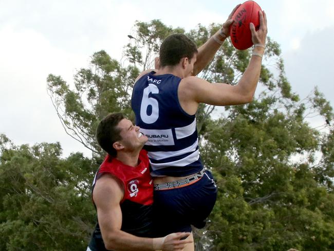 Surfers Paradise Demons player Jack Taylor flies against Broadbeach Cats player Shawn Watson. Picture: Mike Batterham