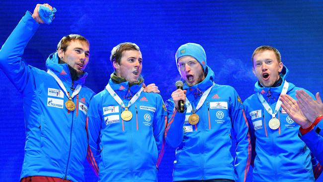 Winners Russia's team Anton Shipulin, Anton Babikov, Maxim Tsvetkov and Alexey Volkov celebrate on the podium for the 2017 IBU World Championships Biathlon Men's 4 x 7.5km relay race.