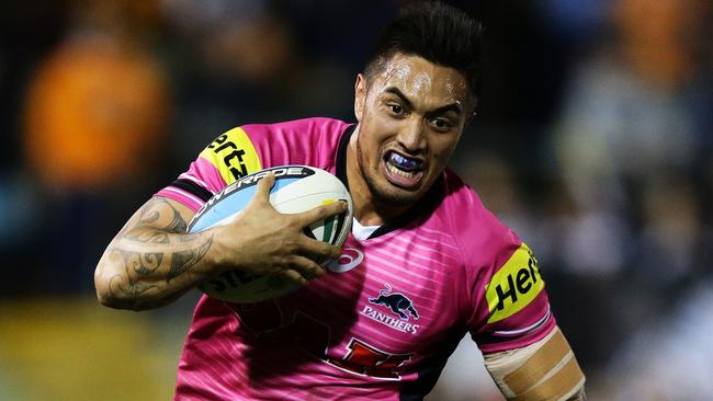 Penrith's Dean Whare beats Tigers Kyle Lovett to set up a try for Penrith's David Simmons during the Wests Tigers v Penrith rugby league game at Leichhardt Oval, Sydney. Pic Brett Costello